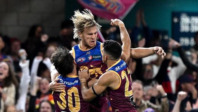 BRISBANE, AUSTRALIA - JUNE 28: Kai Lohmann of the Lions celebrates with team mates after kicking a goal during the round 16 AFL match between Brisbane Lions and Melbourne Demons at The Gabba, on June 28, 2024, in Brisbane, Australia. (Photo by Bradley Kanaris/Getty Images)