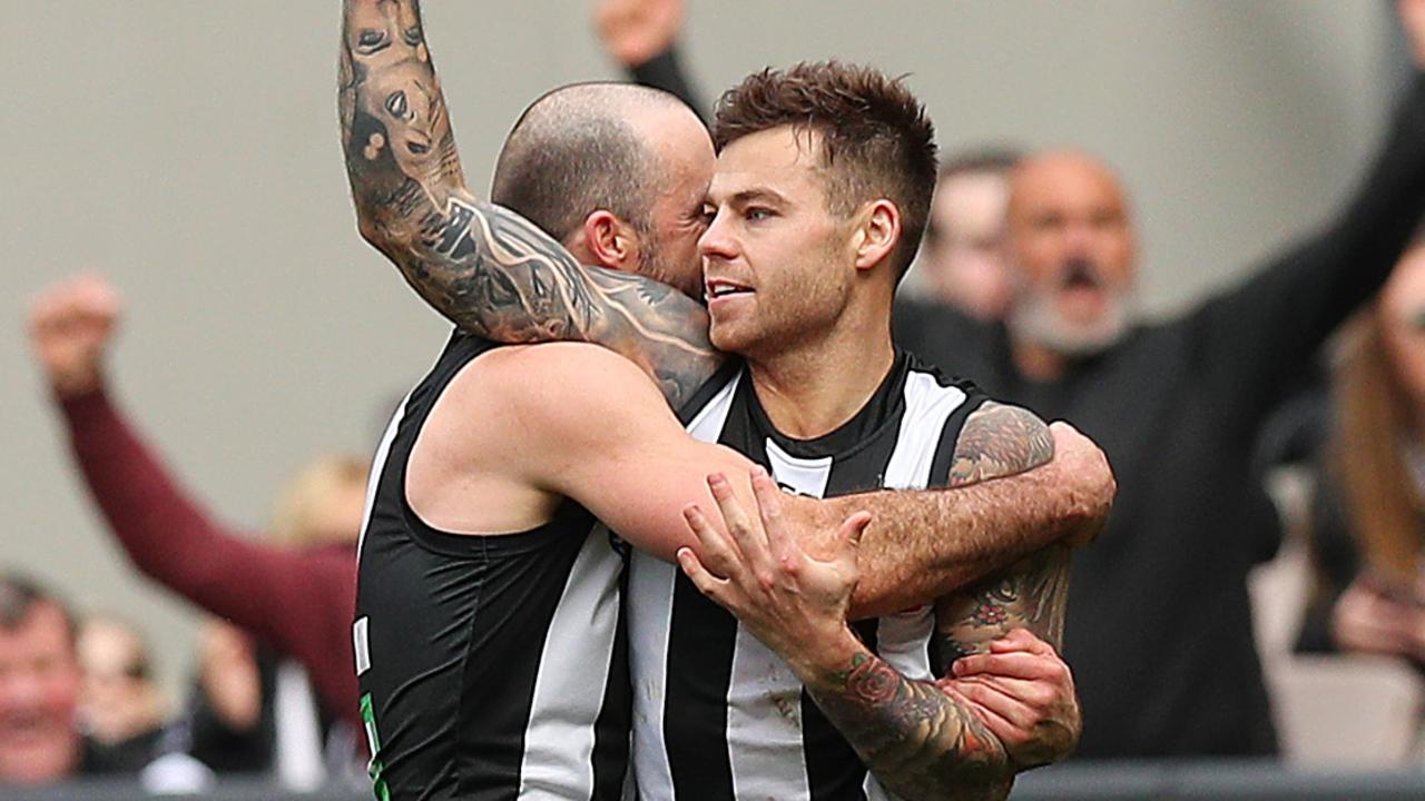 Jamie Elliott gets a hug from Steele Sidebottom after kicking a goal. Picture: Getty Images