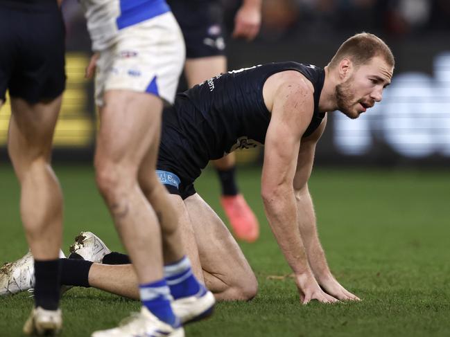 Harry McKay of the Blues was helped to his feet after a heavy collision against North Melbourne. Picture: Darrian Traynor/Getty Images.