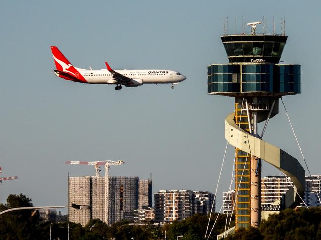 A Qantas B737-838 plane, registration VH-VXU, coming into land on the third runway of Sydney Kingsford-Smith Airport as flight QF579 from Hamilton Island.  In the foreground is the air traffic control tower.  This image was taken from Kyeemagh Avenue, Kyeemagh on a sunny winter afternoon on 10 June 2023.Escape 13 October 2024Doc updatePhoto - iStock