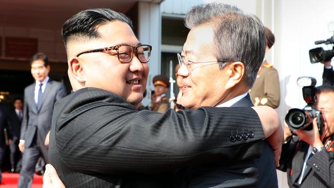 North Korean leader Kim Jong-un, left, hugs South Korean President Moon Jae-in after their summit at on May 26. Picture: AAP.