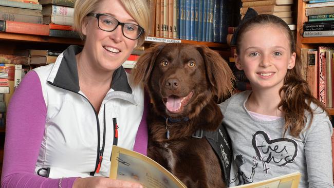 Sarah Macdonald is an English teacher who runs a children's Literacy Business called Canine Comprehension. They use Animal Assisted Therapy dogs to assist in the learning process. By using a canine friendly face, children are motivated to read aloud to the dogs without the embarrassment of making mistakes. They are running a free ANZAC Day Event in conjunction with a local Business in The Basin Rainy Day Books. In an effort to inspire kids to read, and on this day, read stories about our past servicemen, Canine Comprehension will be running reading sessions, where kids can snuggle up to the dogs and hear stories about our diggers and their special service dogs. Pictured with 'Oscar' the dog are Sarah Mcdonald and her niece Caitlin,10. Picture: Lawrence Pinder