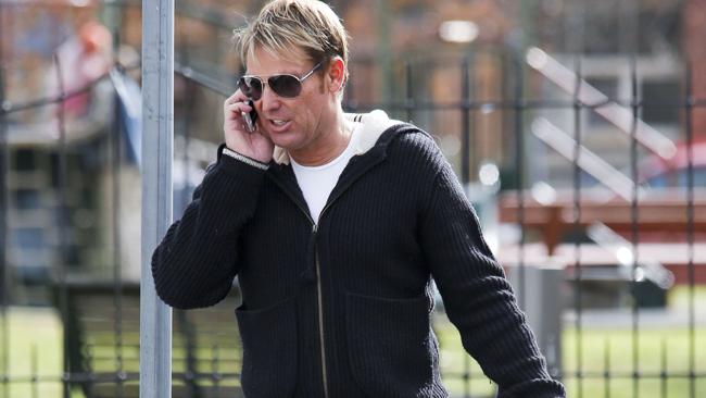 Shane Warne chatting on the phone and smoking. Picture: Splash And Media Mode 