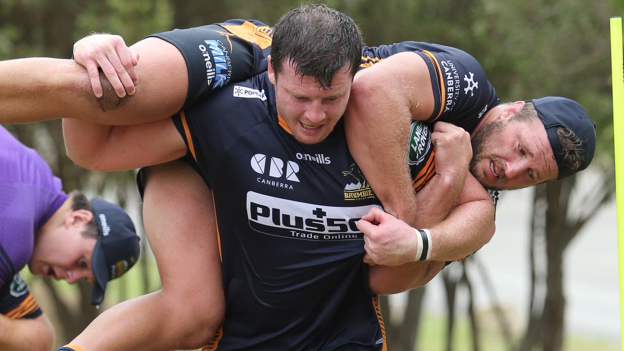 James Slipper of the Brumbies is carried by teammate Murray Douglas.