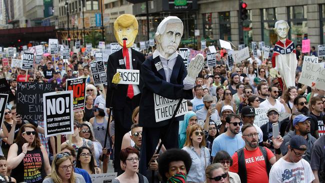 Demonstrators carry effigies of Donald Trump and former vice president Mike Pence during a Chicago protest against hate, white supremacy groups.