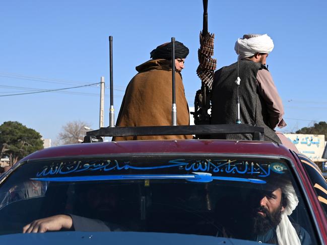 Taliban fighters sit on a vehicle along a road in the Herat on February 3, 2022. (Photo by Wakil Kohsar / AFP)