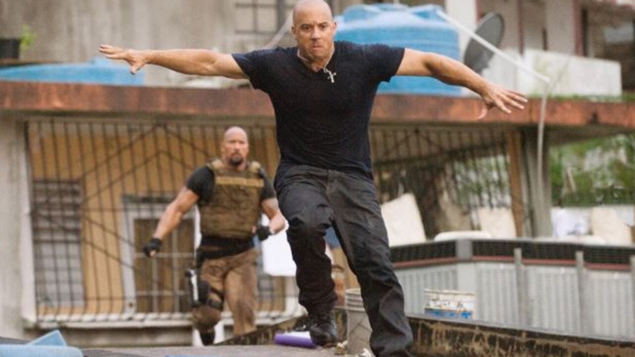 Vin Diesel gets some air in a chase scene with Dwayne Johnson in ‘Fast Five’. Picture: Universal