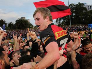 Captain Will Miller is hoisted above the crowd by supporters after Northern Suburbs won the Shute Shield over Sydney University in their grand final clash at North Sydney Oval. Northern Suburbs broke a 41-year premiership drought, taking out the game 28-15. Picture: Troy Snook