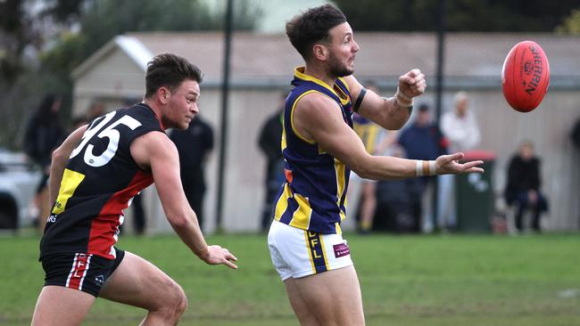 EDFL: Rupertswood’s Matthew Italiano fires off a handball. Picture: Hamish Blair