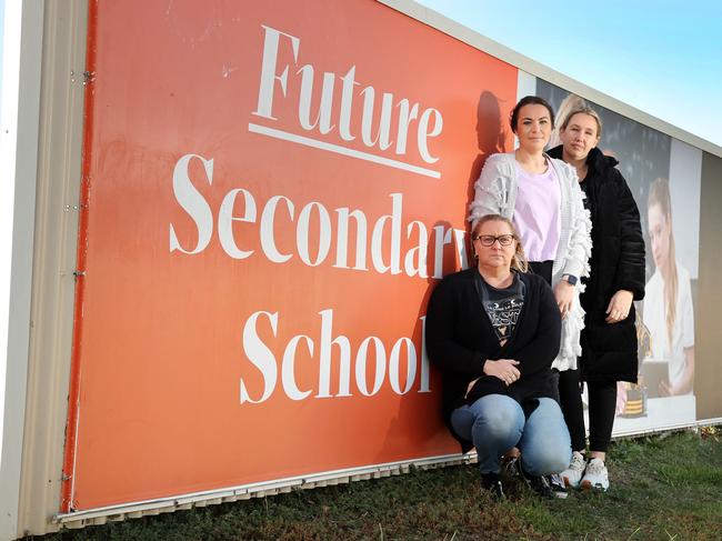 Armstrong Creek parents and residents Sherryn Vessey, left, Lauren Piechota and Jacky Basset at the site earmarked for a secondary school. Picture: Alison Wynd