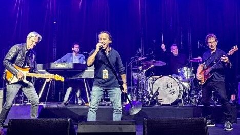 Jimmy Barnes takes a seat at the drums as Phil Small takes vocals at sound check before the band’s warm up show. Picture: Kathy McCabe