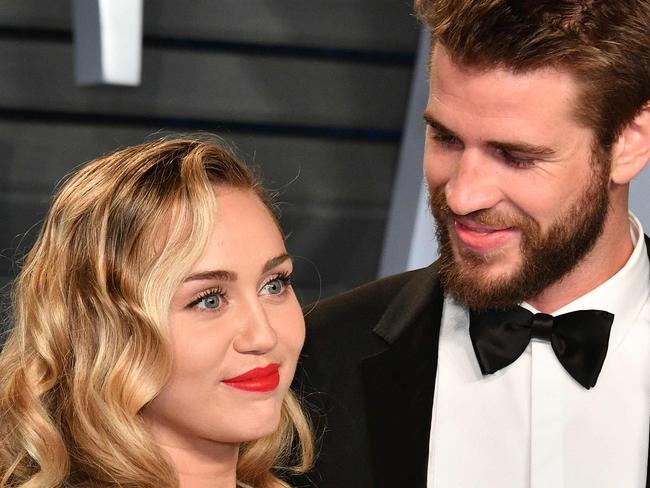 (FILES) In this file photo taken on March 4, 2018 Miley Cyrus (L) and Liam Hemsworth attend the 2018 Vanity Fair Oscar Party hosted by Radhika Jones at Wallis Annenberg Center for the Performing Arts in Beverly Hills, California. - Pop star Miley Cyrus clapped back at her social media haters on August 22, 2019 over her recent split with longtime partner Liam Hemsworth, an Australian actor, to deny allegations that she cheated on him. "I can accept that the life I've chosen means I must live completely open and transparent with my fans who I love, and the public, 100% of the time. What I cannot accept is being told I'm lying to cover up a crime I haven't committed. I have nothing to hide," the 26-year-old superstar tweeted. (Photo by Dia Dipasupil / GETTY IMAGES NORTH AMERICA / AFP)