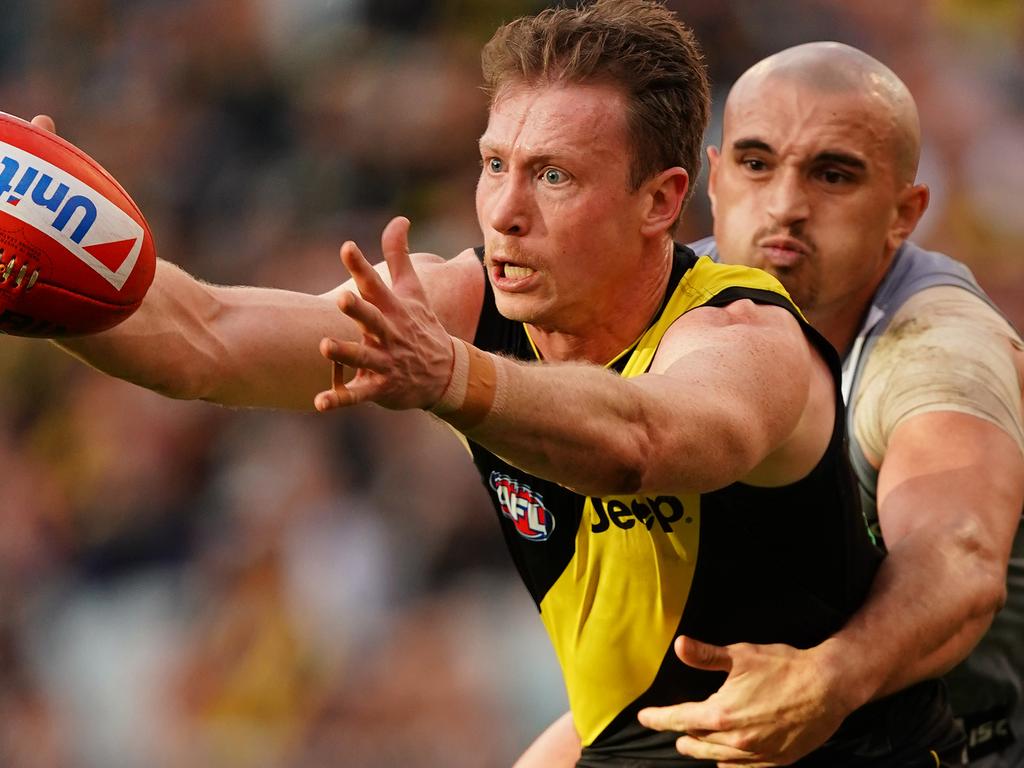 MELBOURNE, AUSTRALIA - JULY 20: Dylan Grimes of the Tigers is tackled by Sam Powell-Pepper of the Power during the round 18 AFL match between the Richmond Tigers and the Port Adelaide Power at Melbourne Cricket Ground on July 20, 2019 in Melbourne, Australia. (Photo by Scott Barbour/Getty Images)