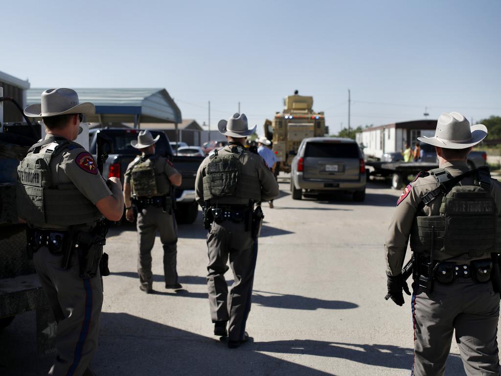 Texas State Troopers advance upon the scene at Big Daddy Zane's near Odessa, Texas. Picture: Eli Hartman/Odessa American via AP