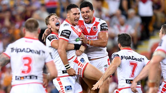 Corey Norman of the Dragons is congratulated by team mates after kicking the winning field goal. 