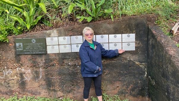 Michael 'Mick' Flynn's wife Gabrielle with the plaque before it went missing from a Dicky Beach lifesaving memorial.