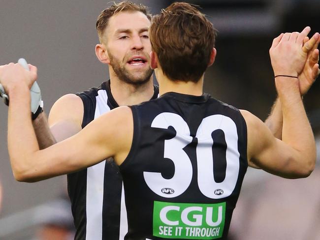 MELBOURNE, AUSTRALIA - JULY 30: Travis Cloke of the Magpies (L) and Darcy Moore celebrate a goal during the round 19 AFL match between the Collingwood Magpies and the West Coast Eagles at Melbourne Cricket Ground on July 30, 2016 in Melbourne, Australia. (Photo by Michael Dodge/Getty Images)