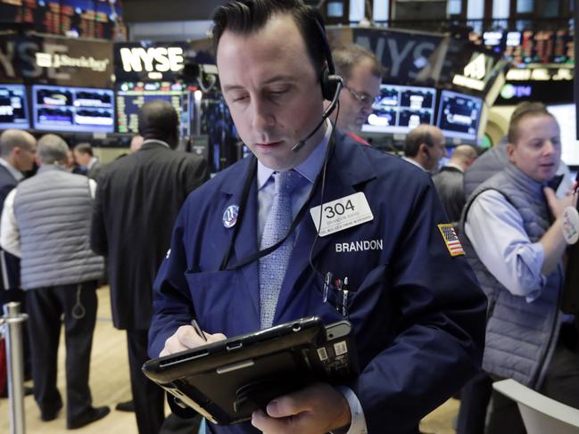Trader Brandon Barb works on the floor of the New York Stock Exchange, Monday, Nov. 2, 2015. Stocks opened slightly higher on Wall Street as the market comes off its biggest monthly gain in four years. Health care stocks were among the early winners. (AP Photo/Richard Drew)
