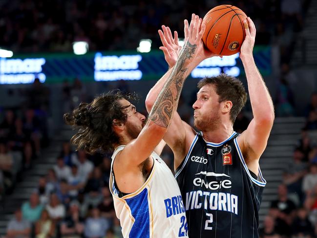 MELBOURNE, AUSTRALIA - DECEMBER 08: Robert Loe of United looks to pass the ball under pressure from Tyrell Harrison of the Bullets during the round 11 NBL match between Melbourne United and Brisbane Bullets at John Cain Arena, on December 08, 2024, in Melbourne, Australia. (Photo by Josh Chadwick/Getty Images)