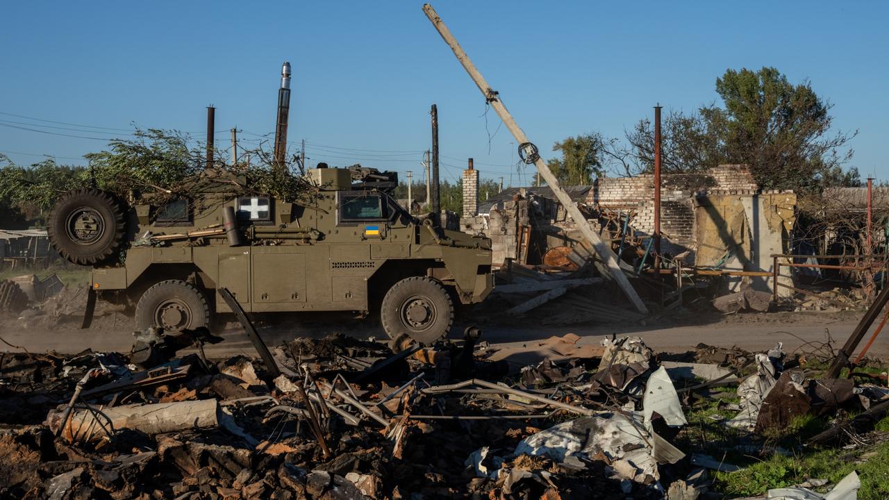 An Australian-built Bushmaster armoured vehicle driving through destroyed buildings on October 08, 2022 in Lozove, Ukraine. Picture: Getty Images