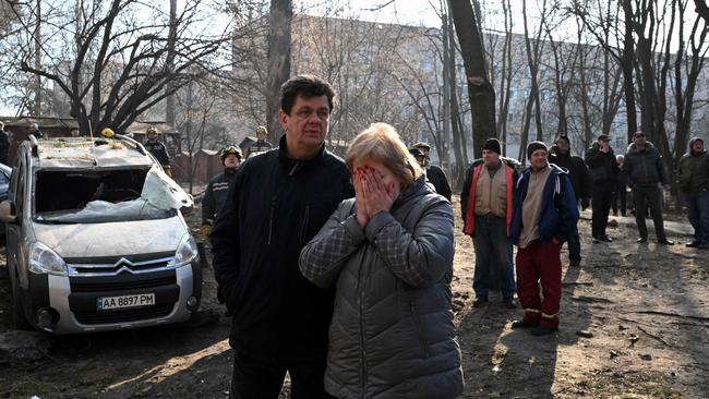 Evacuated residents outside their 16-storey residential building which was destroyed in Kyiv on March 15 after strikes on residential areas killed at least two people.