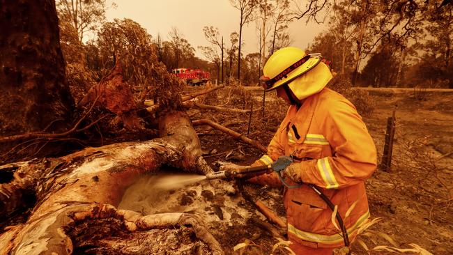 Fire crews put out spotfires during the bushfire which destroyed 60 homes in Sarsfield.