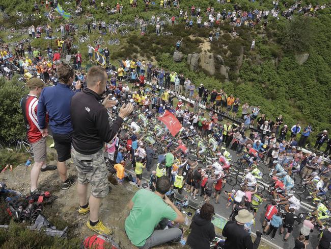 Spectators line the road as the pack climbs Blubberhouses pass.