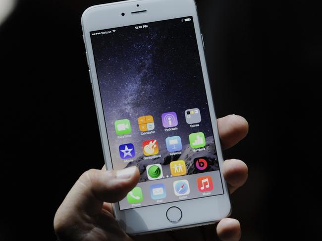 An attendee demonstrates the new Apple Inc. iPhone 6 Plus after a product announcement at Flint Center in Cupertino, California, U.S., on Tuesday, Sept. 9, 2014. Apple Inc. unveiled redesigned iPhones with bigger screens, overhauling its top-selling product in an event that gives the clearest sign yet of the company's product direction under Chief Executive Officer Tim Cook. Photographer: David Paul Morris/Bloomberg