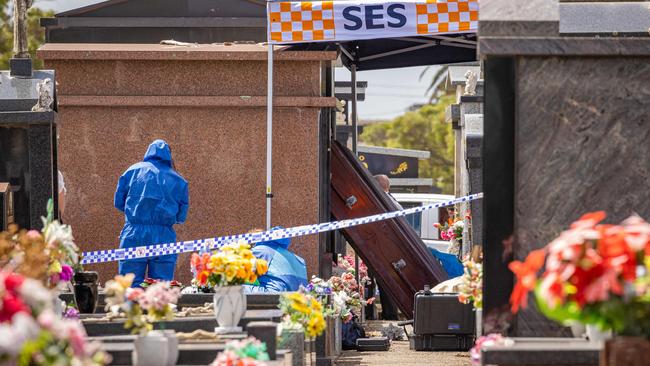 Detectives and forensics examining the area where human remains were stolen. Picture: Jason Edwards