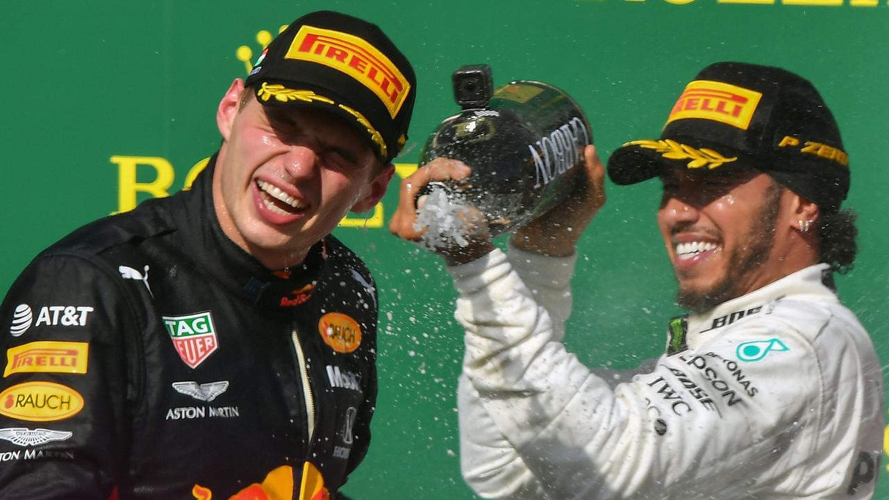 Max Verstappen and Lewis Hamilton celebrate on the podium in Hungary.