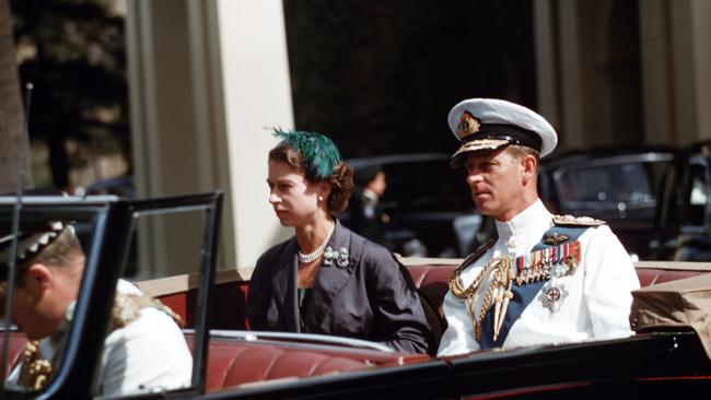 Queen Elizabeth II and Prince Philip, the Duke of Edinburgh, are pictured in their car on the way to the Adelaide War Memorial in 1954.