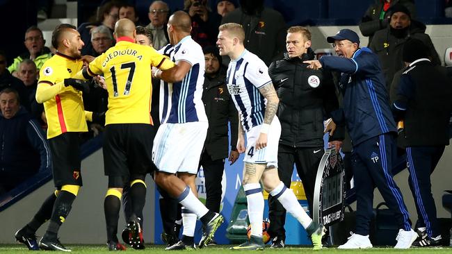 Tony Pulis, manager of West Bromwich Albion reacts (R) to a fight.