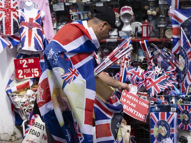 A worker prepares a Platinum Jubilee themed display outside a shop in Windsor. Picture: Dan Kitwood/Getty Images