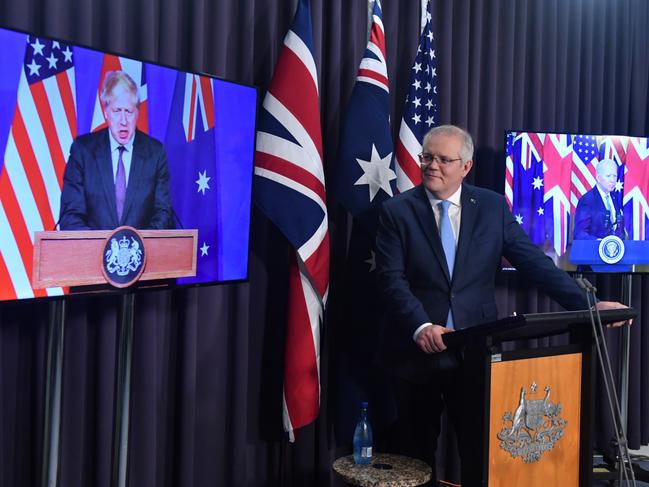 Prime Minister Scott Morrison at the press conference to announce the deal with UK Prime Minister Boris Johnson (left) and US President Joe Biden.