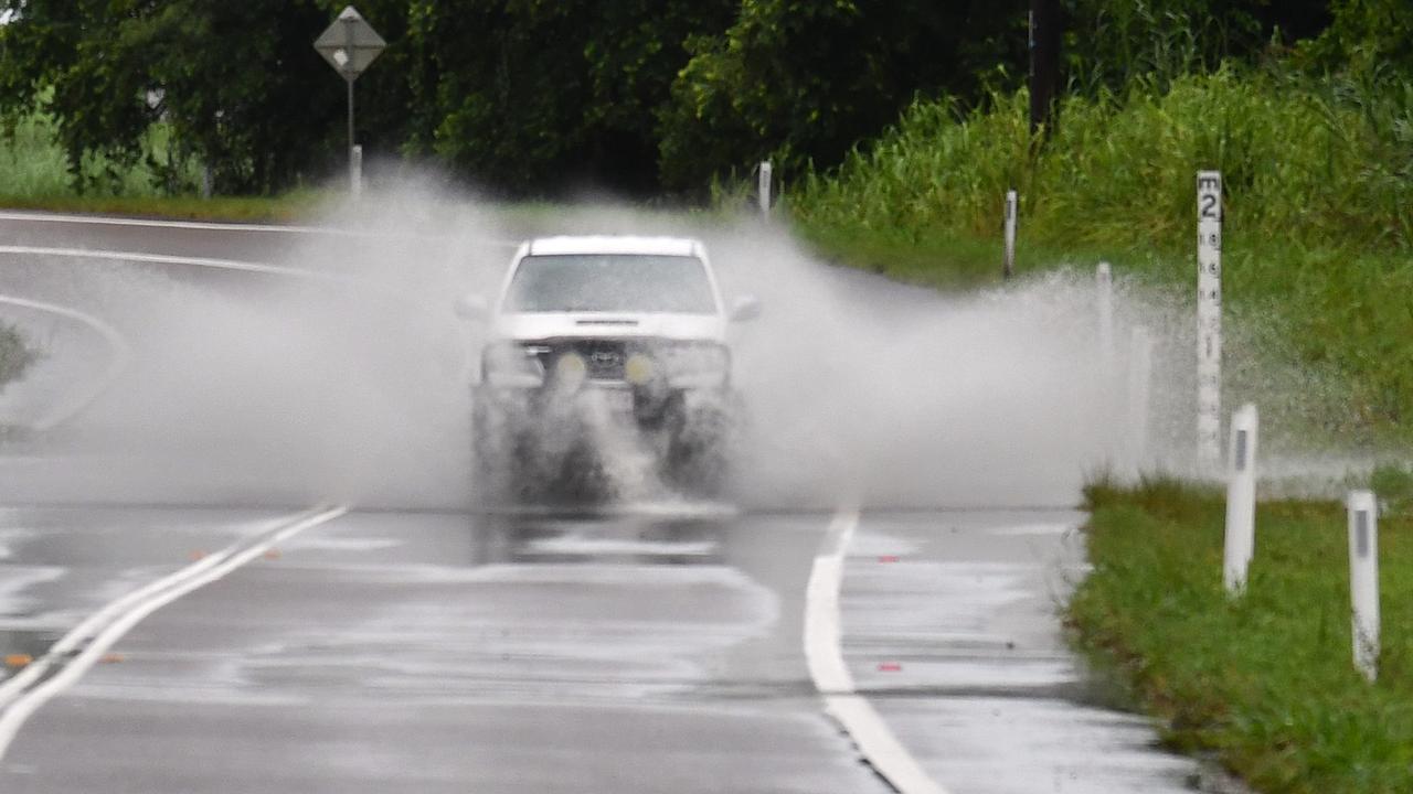 A vehicle navigates the notorious flood-prone Gairloch Washaway between Ingham and Cardwell on Wednesday morning. Picture: Cameron Bates