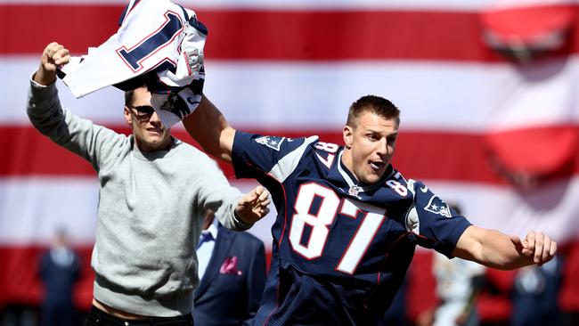 Rob Gronkowski of the New England Patriots steals Tom Brady's jersey before the opening day game between the Boston Red Sox and the Pittsburgh Pirates at Fenway Park.
