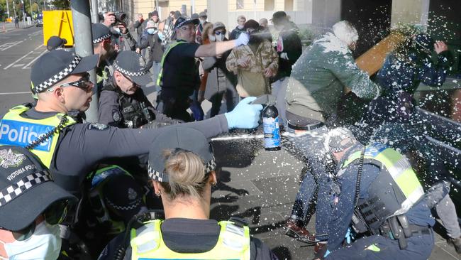 Protesters clash in Spring st in Melbourne and police moved in to make arrests. Picture: NCA NewsWire / David Crosling