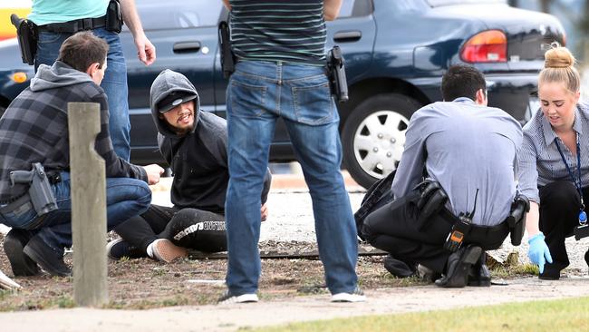 SOG arrests...cnr Heatherton and Stud Roads, Dandenong. Second detainee is questioned and his bag searched. Picture : Mike Keating.