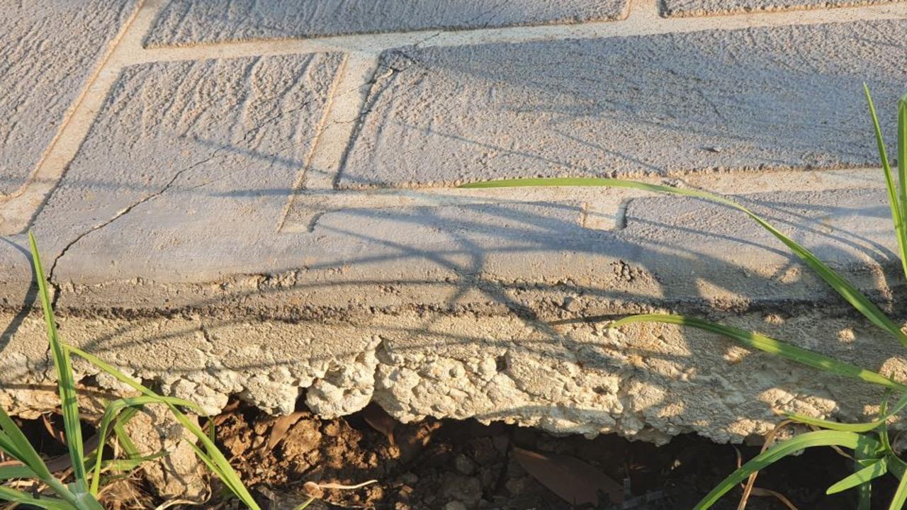 The driveway and front lawn of one home sank as a result of subsidence.