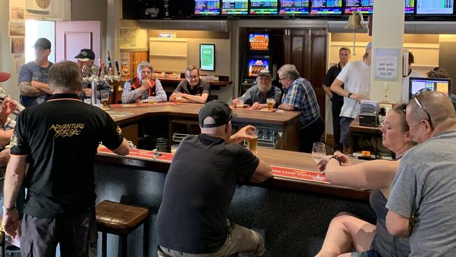 People drinking at the Mona Castle hotel, Seddon.