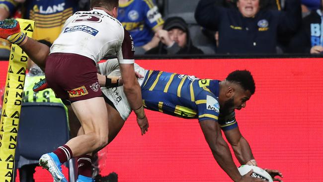 Parramatta's Maika Sivo dives for the tryline against Manly on Friday night. Picture: Brett Costello