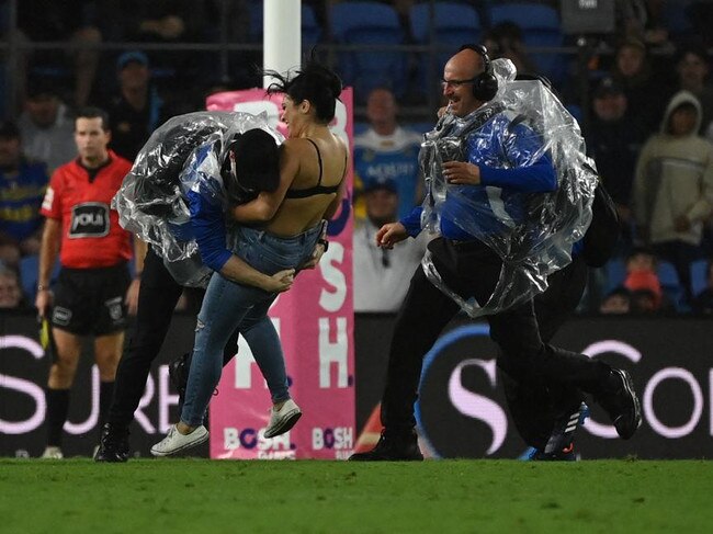 Streaker, Javon Johanson, gets tackled by security on the Gold Coast. NRL Imagery