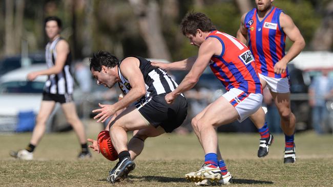 Nepean league football preliminary final between Crib Point and Rye at Hastings. Crib Point #15 David Cook under pressure from Rye #15 Leigh Morse. Picture: Chris Eastman