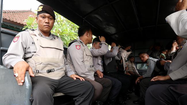 Police officers arrive at the Bali Parole office in Denpasar to prepare for Schapelle Corby to report one last time before she is transported to the airport by Indonesian Immigration for deportation to Australia. Picture: Nathan Edwards.