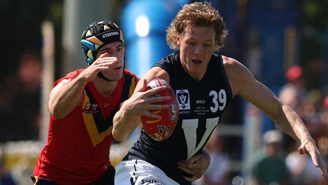 ADELAIDE, AUSTRALIA - APRIL 06: Josh Ryan of South Australia tackles Hugh Dixon of Victoria during the 2024 AAMI State Game between SANFL West End State Team and Smithy's VFL State Team at Glenelg Oval, on April 06, 2024, in Adelaide, Australia. (Photo by Maya Thompson/AFL Photos/via Getty Images)