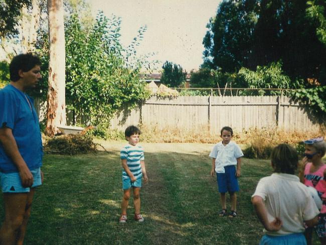 Father Chris Pike with son Ben Pike (second from left) and friends in the backyard at Pennant Hills.