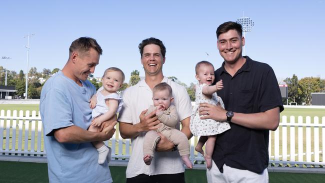 Cricket dads Marnus Labuschagne and daughter Hallie, Mitch Swepson and son Beau and Matthew Renshaw and daughter Charlotte ahead of their first Father's Day. Picture: David Kelly