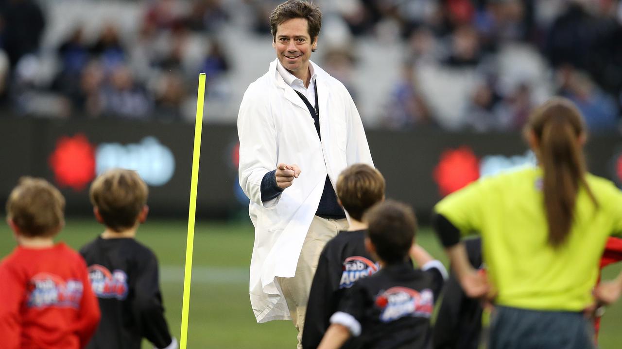 AFL boss Gillon McLachlan umpires an Auskick match in 2018. Picture: Michael Klein