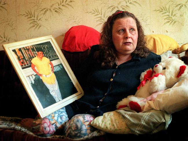 Barbara Phillips with a picture of her murdered daughter and the girl’s teddy bear.