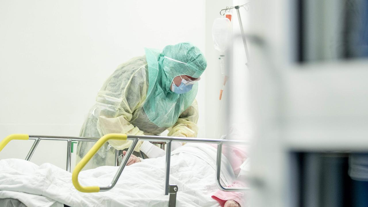 A nurse in protective clothes takes a blood sample of a patient potentially infected by COVID-19. Picture: Roni Lehti/AFP